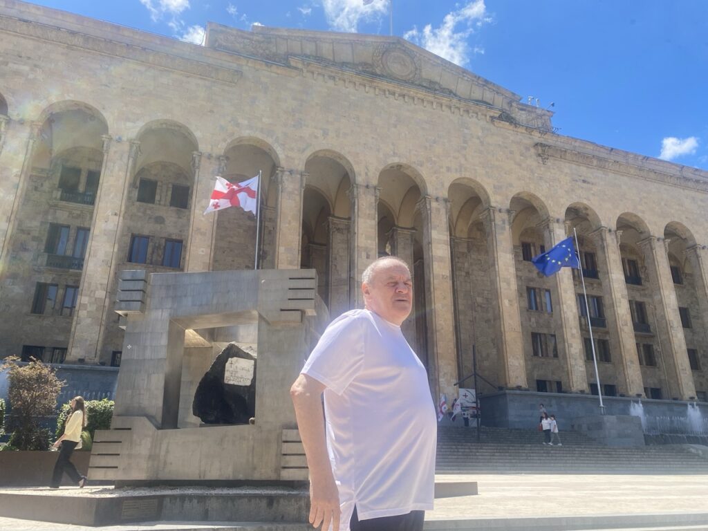 June 15, 2026 Lex’s father in front of the Parliament of Georgia, in Tbilisi. Georgia is not an official member of the EU, but the EU flag is always there as the symbol of hope.